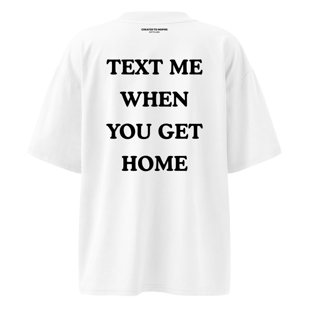 White t-shirt with black text 'TEXT ME WHEN YOU GET HOME' on a white background