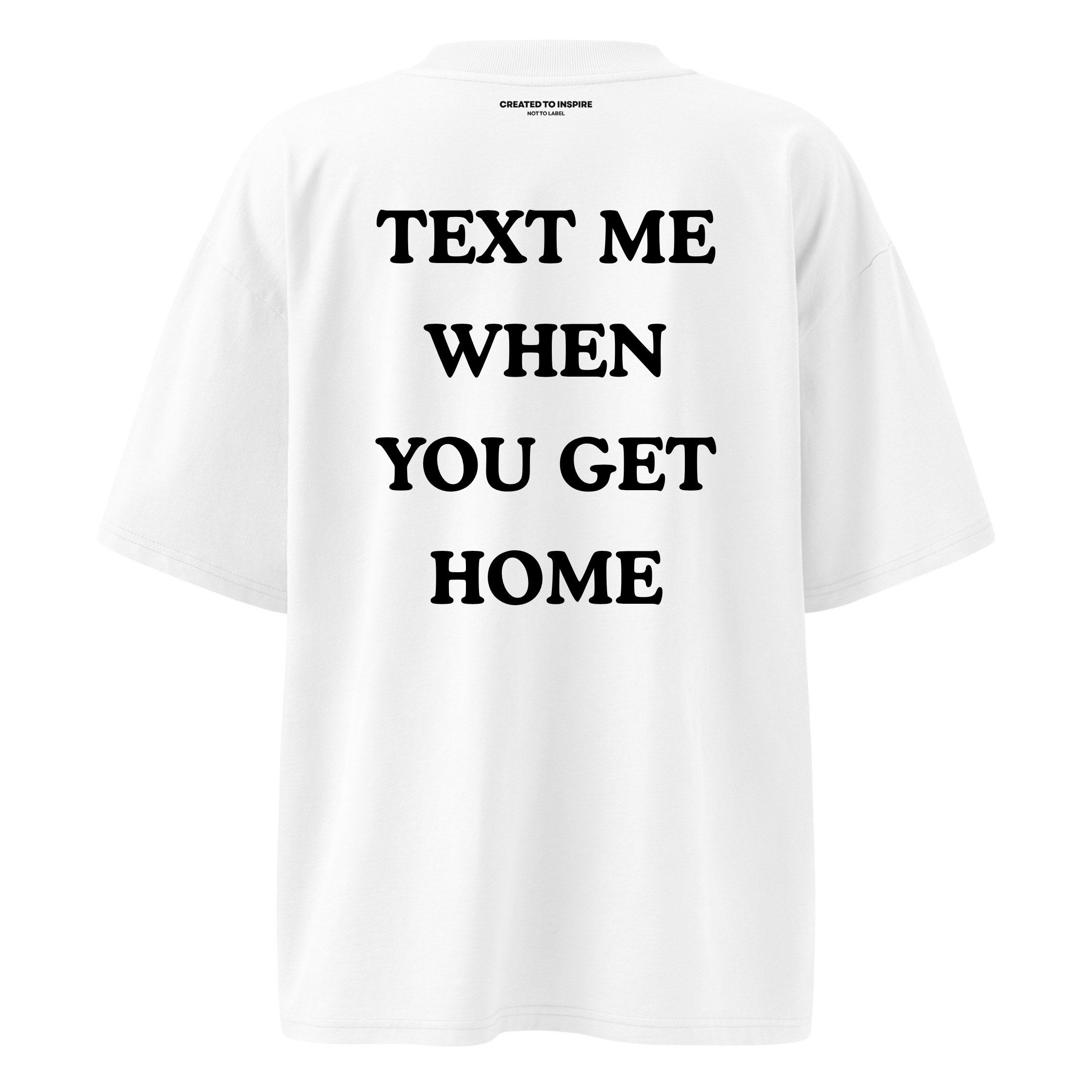 White t-shirt with black text 'TEXT ME WHEN YOU GET HOME' on a white background